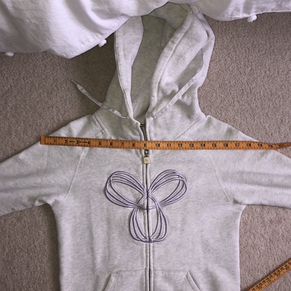 Very light grey TNA zip up with light purple logo - Picture 11 of 11